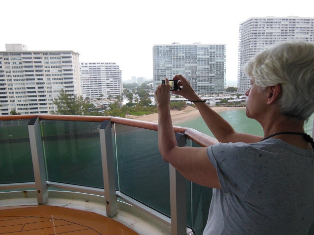 Carol Anne photographing the Port Everglades port from our Stateroom Balcony as the Victoria was docking. The Ship captain is a woman from Denmark, only one of two women who captains ships for Carnaval/Cunard. So far she has missed all obstacles. In San Francisco, rumor is, she gets replaced by a guy.